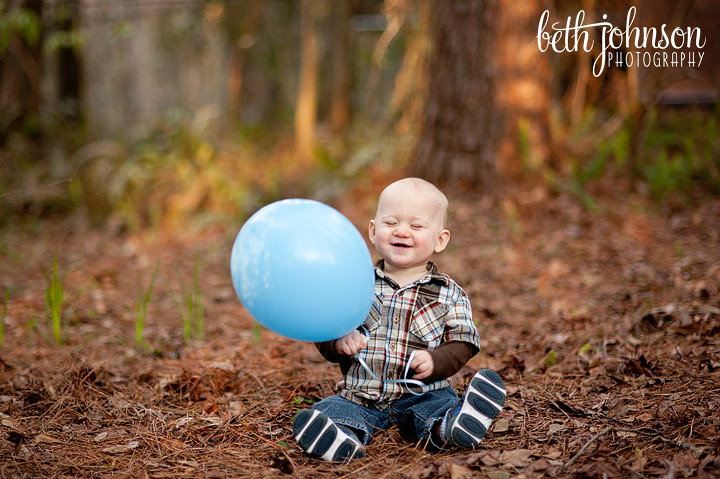 first birthday boy with blue balloon
