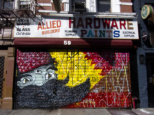 Painted steel rolldown gate of East Village hardware store