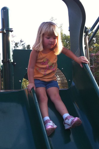 She goes down the big slide on the playground by herself now
