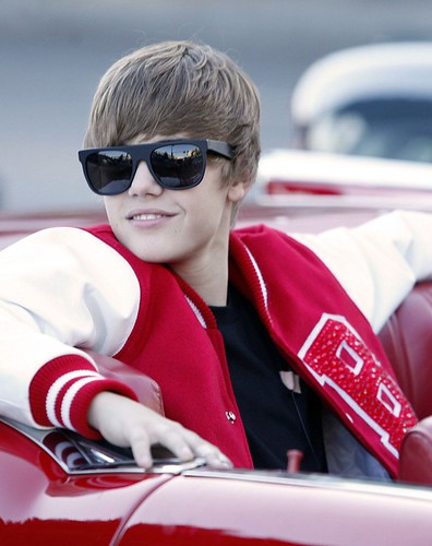 44726, LOS ANGELES, CALIFORNIA - Friday September 10, 2010. **EXCLUSIVE** Justin Bieber poses for an MTV interview in the back of a stylish red and white cadillac whilst wearing a matching red and white football style Bieber jacket outside the Nokia Centr