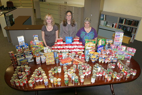Feds Feed Families:  (left to right), Traci Ross, Farm Service Agency Coordinator; Tammi Schone, Rural Development Coordinator; and Linda Weinzetl, Natural Resources Conservation Service Coordinator with some of the food collected for the backpack program. 