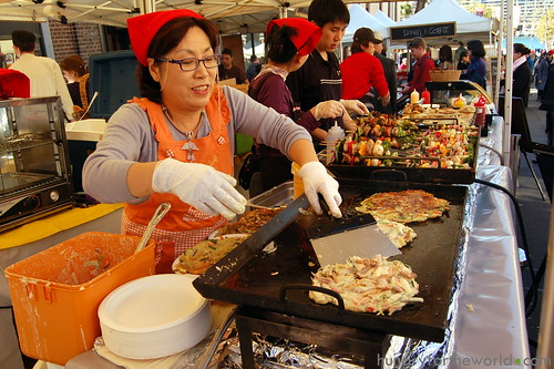 happily preparing okonomiyaki