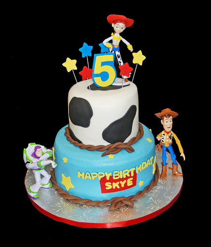 5th Birthday Cow print and stars 2 tiered cake with Toy Story figurines