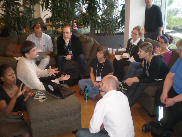 Photo of many different people working together in a discussion