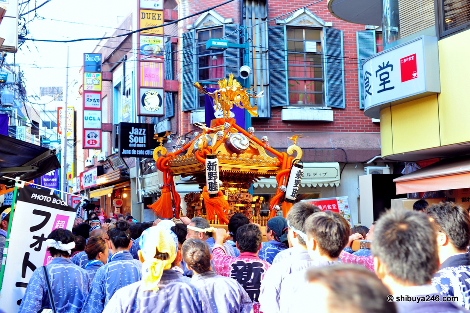 The omikoshi gets carried through the narrow streets