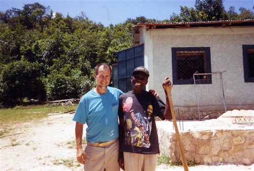 Image of Jeff Behringer with a Haitian adult, a member of a Haitian community helped by Jeff's expertise in stone masonry and by profits from Behringer Stone Masonry company