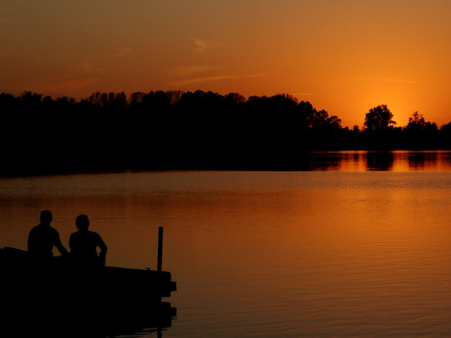 Creve Coeur Lake, in Maryland Heights, Missouri, USA - couple gazing into the sunset