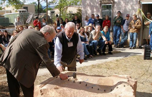 Dave Conine, Utah Rural Development State Director, (left) followed directions in cutting 4,000 pound stone in half the old fashioned way, without any power tools. 