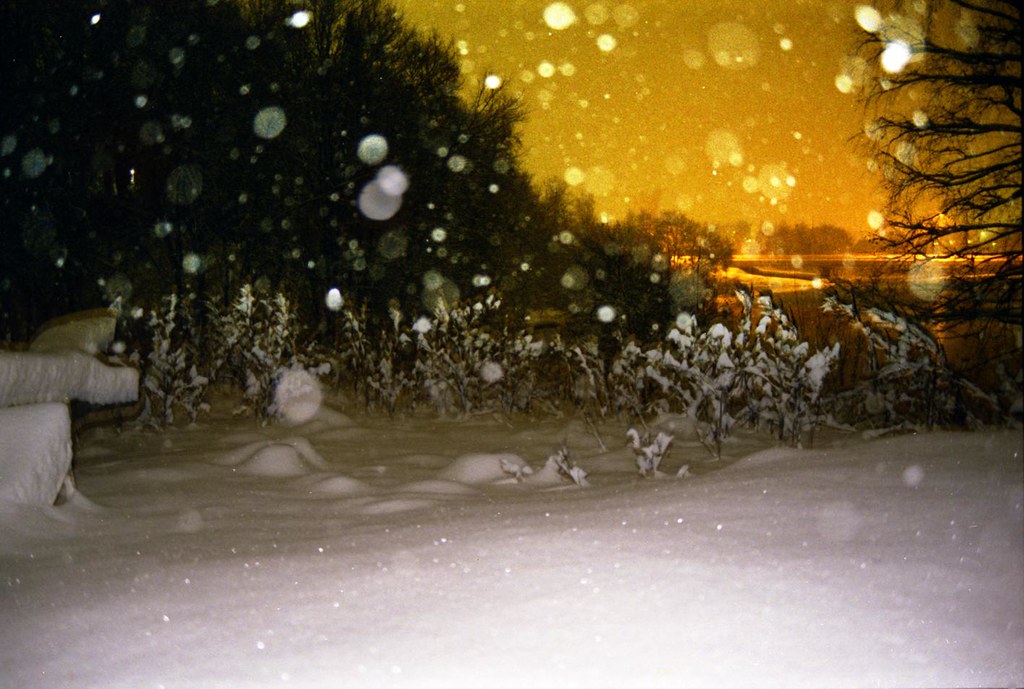 : Falling snow on the outskirts of city