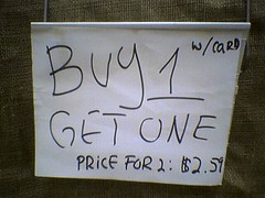 Supermarket "sale" sign: "BUY 1...