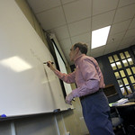 Dr. Fischmar taking notes on the white board.