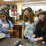 Summer camp student performing experiments with the help of summer work study students