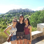 Honors students Danielle Grady, Emma Pollock, and Jessica Grady pose with the Acropolis in the background on the Greece trip.