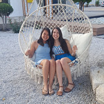 Honors students Jessica Grady and Taylor Chock-Wong pose on a chair in Samos during their Greece trip.