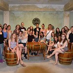 Honors students pose together in a wine cellar that they visited in Samos.