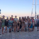 Honors students get a group picture together at a port next to the sea in Greece.