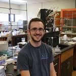 A student in the lab poses for a photo