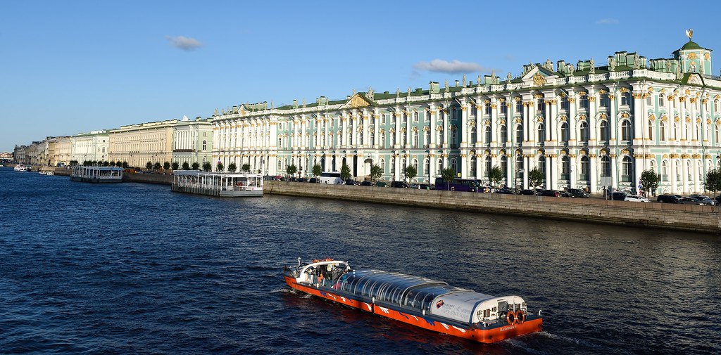 : Neva River pleasure boat passing the Winter Palace in Saint Petersburg, Russia