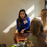 An alumna talking with students at a Professional Networking Symposium