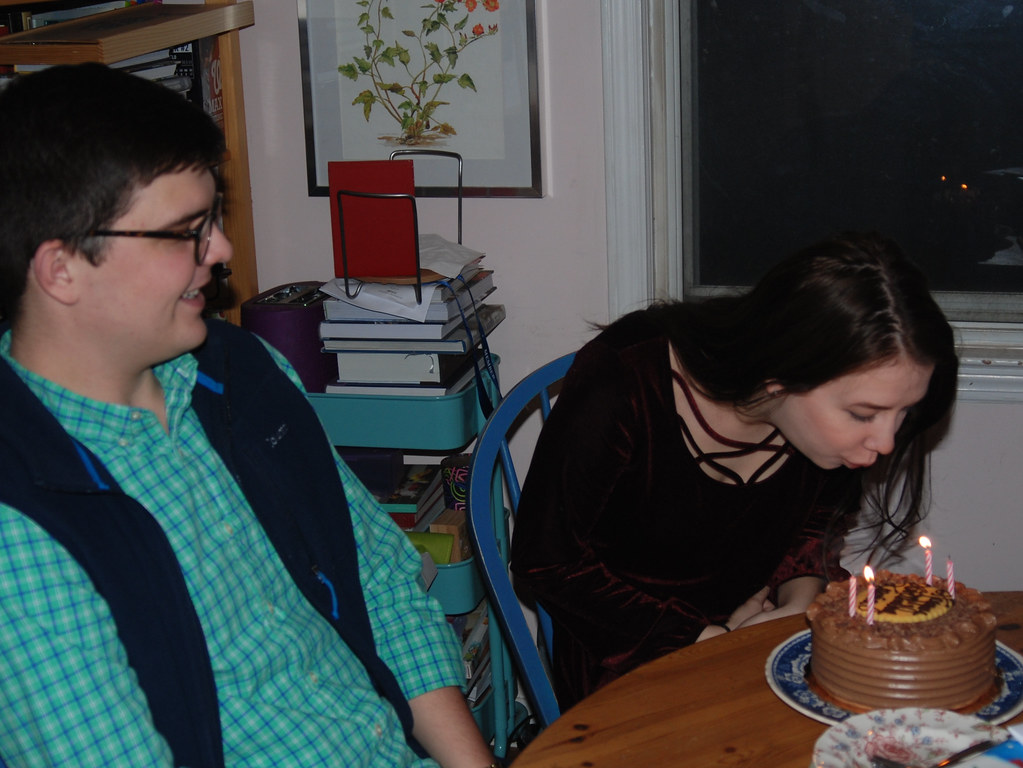 : Ksenia blowing out candles on birthday cake