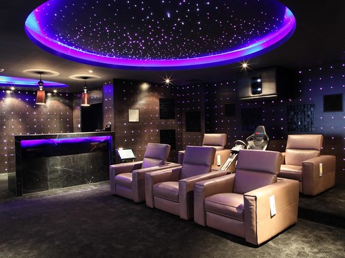 small-home-theater-ideas-big-screen-on-the-beige-wall-long-table-bar-interior-brown-fabric-sofas-red-color-curve-shape-sofas-two-white-sofa-chair
