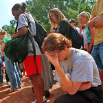 A student prays during a Brickyard vigil on 9/11.