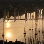 Ice sculptures and sunset in a frozen beach of the Baltic sea