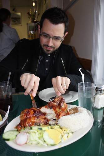 Rand tries some chicken. I dont know why it looks like hes concentrating so hard, but I think its cute.