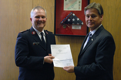 Major Richard Amick receives a check from Jim Freeman of One America Bank. 