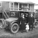 John Schafer with wife Neta Smith Schafer and daughter Bernice beside 1922 Buick Six automobile at railroad logging camp