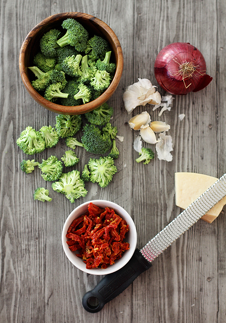 Overhead view of the ingredients needed to make sausage and broccoli bow tie pasta. 