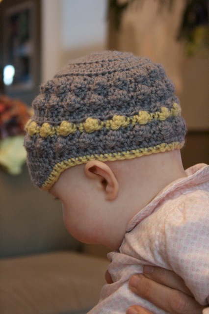 Flicka models crocheted babe hat
