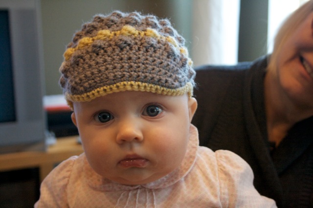 Flicka models crocheted babe hat