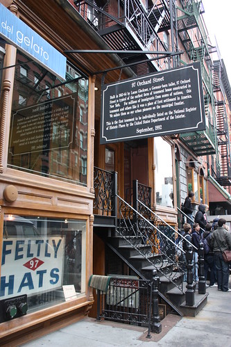 A plaque denotes the entrance to the Tenement Museum.