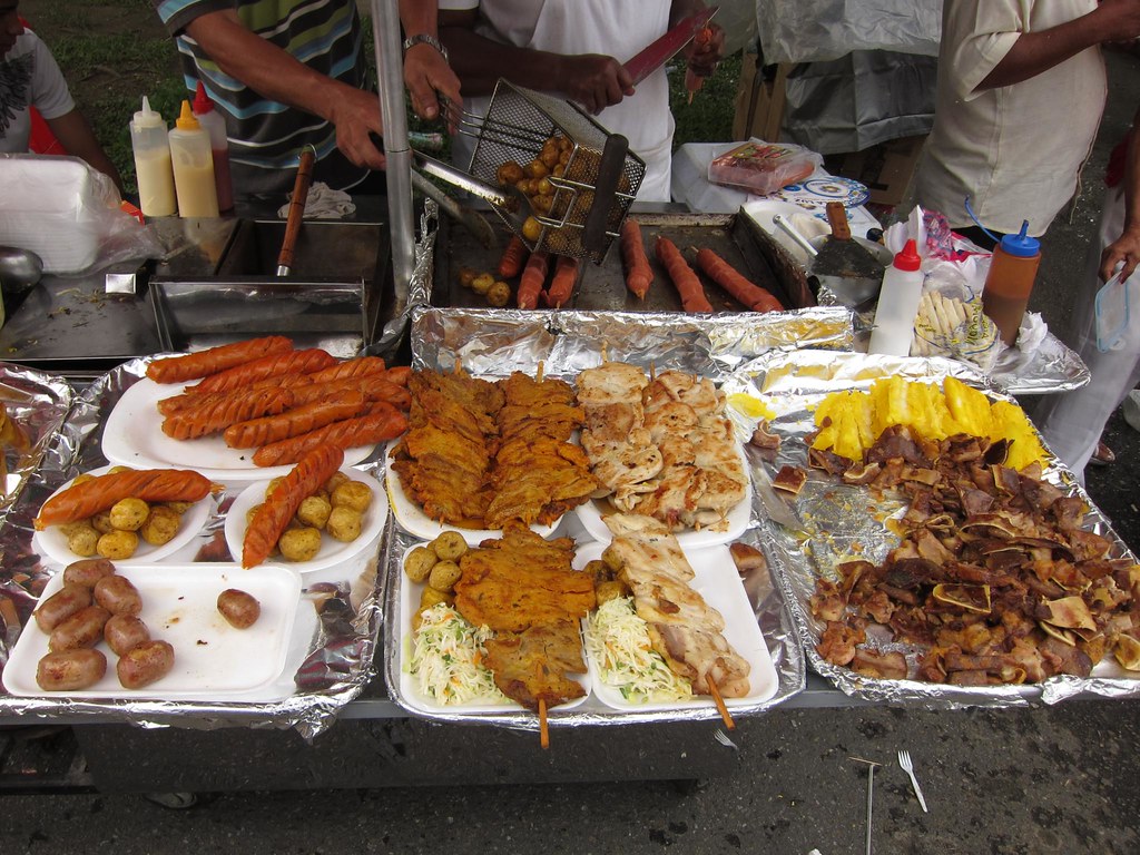 Typical Colombian street food: chicken, chorizo, potatoes, and (possibly) crispy pig ears to the right.