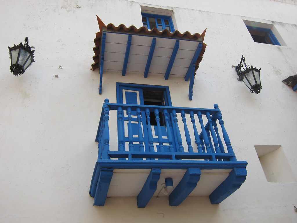 Balconies and hanging lamps are common on the building facades in the old city center.