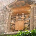 Close up of stone carving above the entrance of Bibury Court Hotel