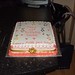 Square 50th birthday cake with handpainted cats and paw decoration.
