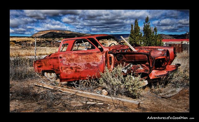An abandoned car on sits in decay on the side of Route 66 in Pueblo of Laguna, New Mexico