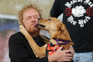 Dog giving man a kiss at NYC Strut Your Mutt