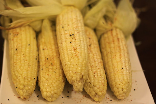 Oven Roasted corn smeared with butter sprinkle with black sesame, chili powder and paprika