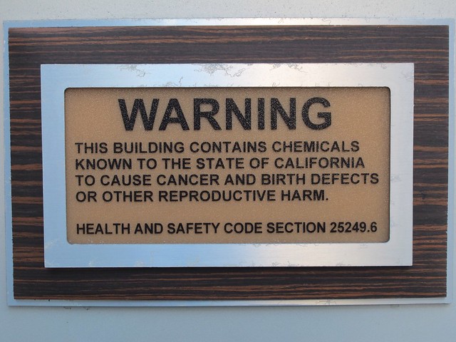 Warning sign at hotel back entrance