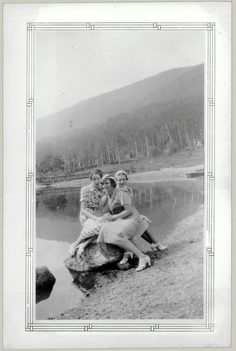 Three girls sitting on a rock