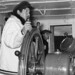 Inuit pilot of the Eastern Arctic Patrol ship MV Regina Polaris, with Samuel D. Ford... / Pilote inuit du navire à moteur Regina Polaris de la patrouille de l’est de l’Arctique... En arrière-plan : Samuel D. Ford
