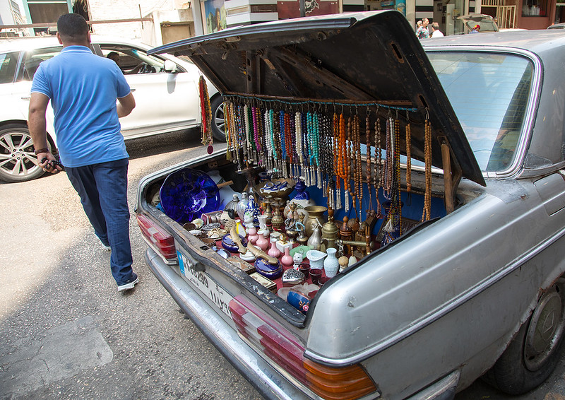A man selling prayer beads and souvenir from the trunk of his car in the street, Beirut Governorate, Beirut, Lebanon<br/>© <a href="https://flickr.com/people/41622708@N00" target="_blank" rel="nofollow">41622708@N00</a> (<a href="https://flickr.com/photo.gne?id=33924875133" target="_blank" rel="nofollow">Flickr</a>)
