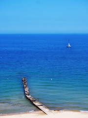 lone sailboat on blue water