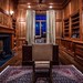 Eagle’s Nest Estate’s Private Office - An English barrister office designed with custom hand-made solid cherry wood crafted paneling and cabinetry by master craftsmen Gary Roberts and Gordon Elliott with Rocky Mountain hardware. The DESA 42” wood burning