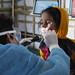 UK Emergency Medical Team paediatric nurse, Becky Platt, checks a girl for symptoms of Diphtheria in the Kutapalong refugee camp, Bangladesh