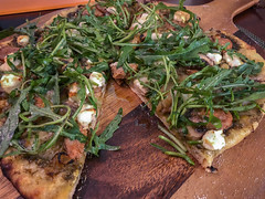 Basil Pesto Pizza with Spicy Itailian Sausage, Carmelized Onions, 3 Cheese and Dressed Rocket