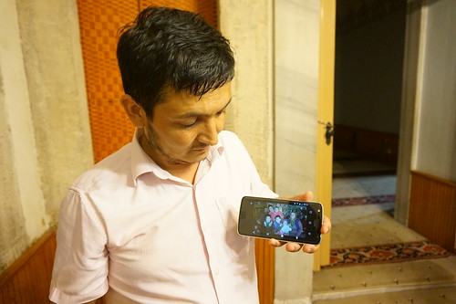 A Uyghur man in Istanbul shows a photo of his family, beleived to be in a re-education camp in Xinjiang, China.